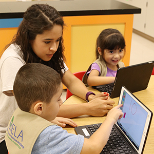Baylor student teaching a child math on iPad
