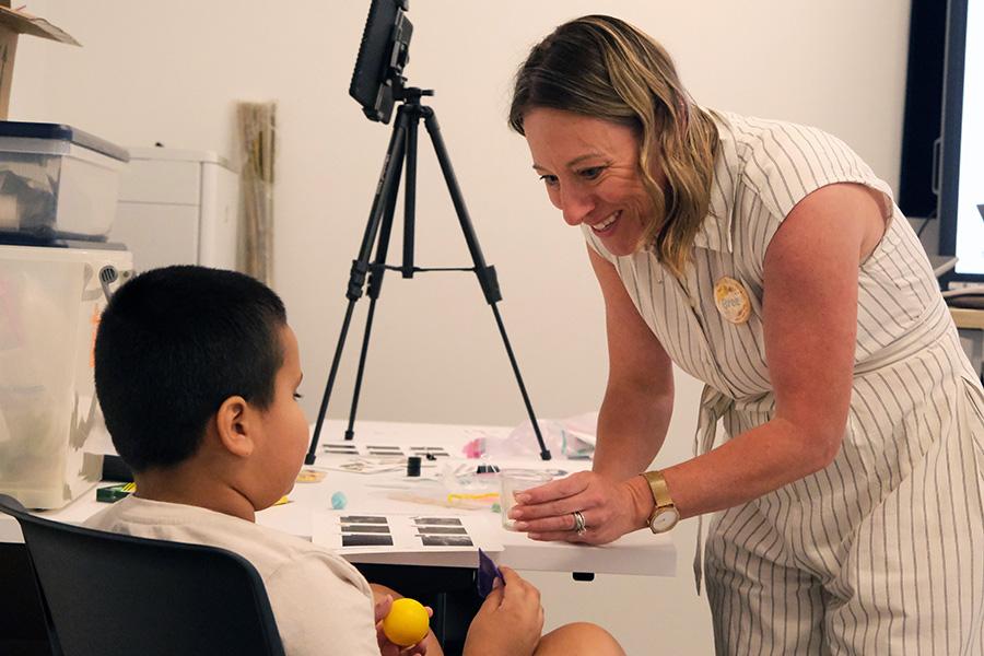 Dr. Bree Jimenez helps a young student with an engineering project